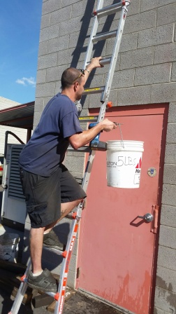 REVX fastener holding five pound bucket up a ladder